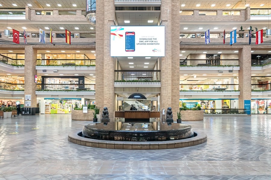 Retail shopping space with a large video display drawing the shopper’s eye upwards.