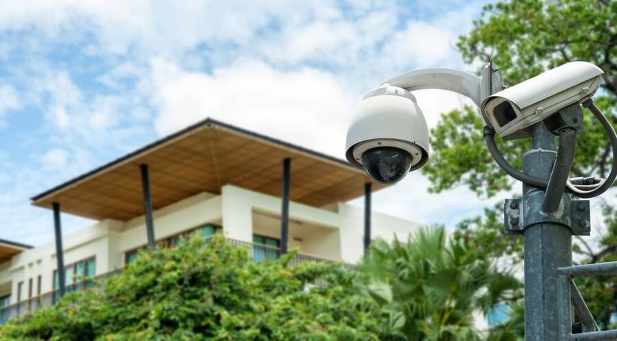 A luxury home with a video security camera outside.