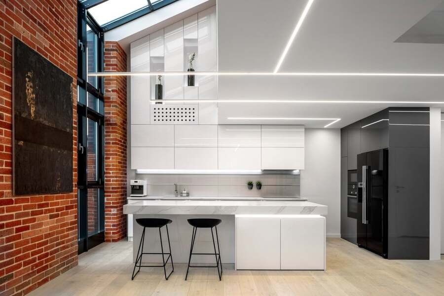 A luxury kitchen illuminated by LED lighting.